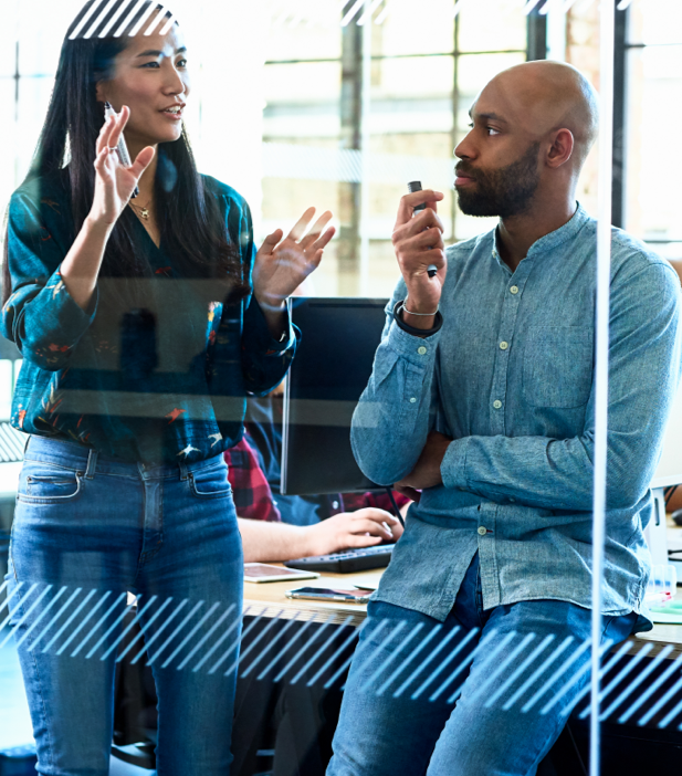 a woman gestures with her hands as she speaks with a colleague