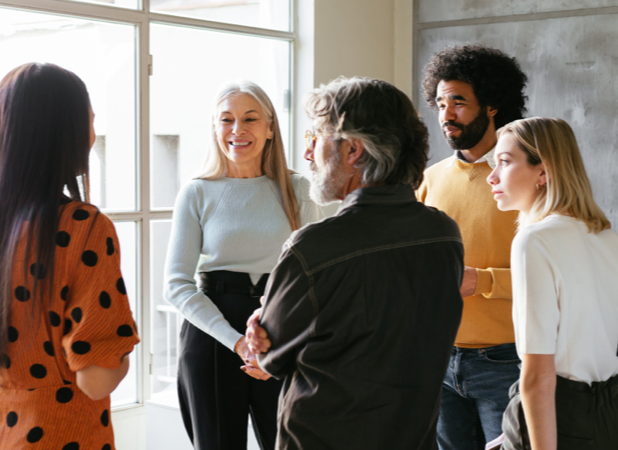Diverse group of employees having a stand up meeting